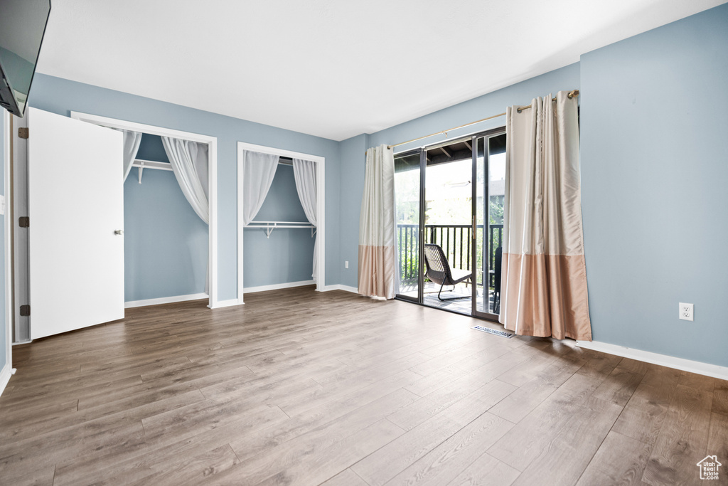Unfurnished room with wood finished floors and baseboards