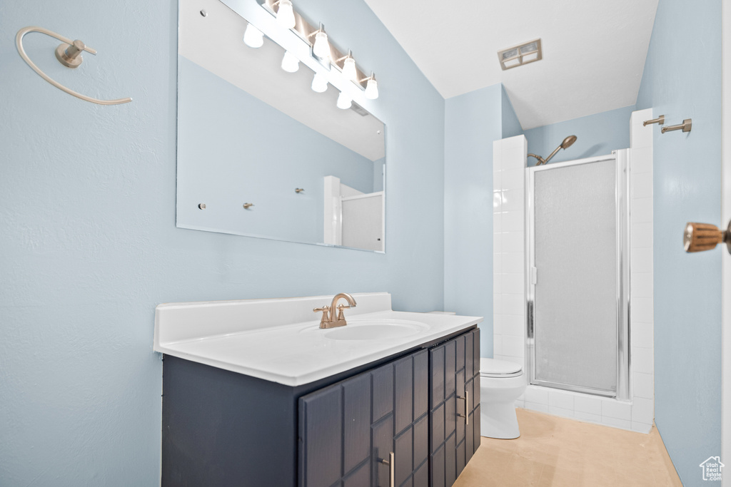 Full bathroom with a stall shower, vanity, and tile patterned floors