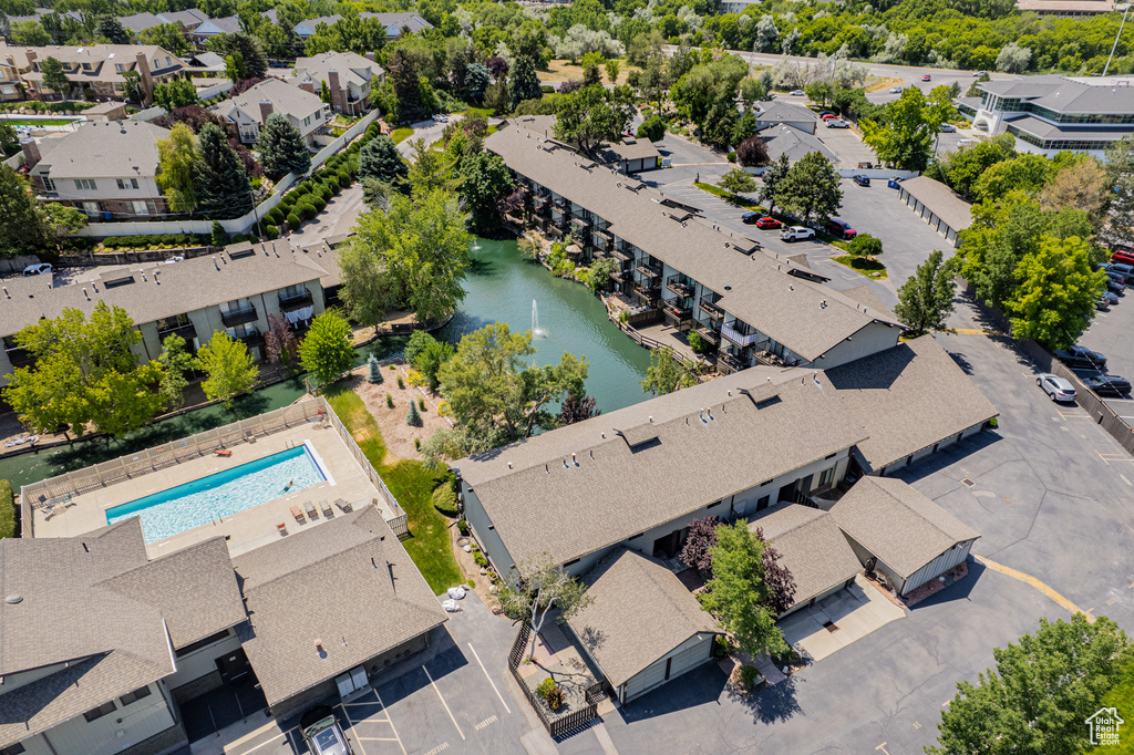 Aerial view of residential area with a pool and a nearby body of water