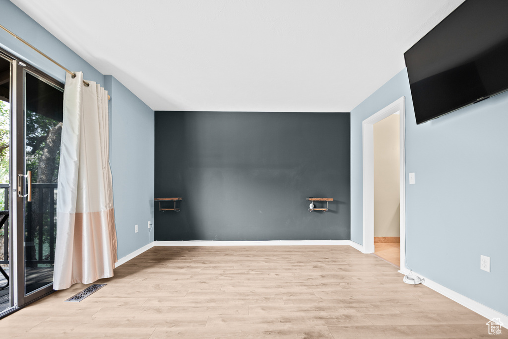 Empty room featuring wood finished floors