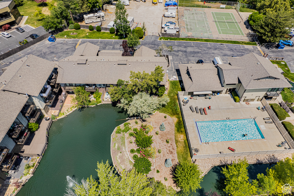 Drone / aerial view of a nearby body of water and a pool