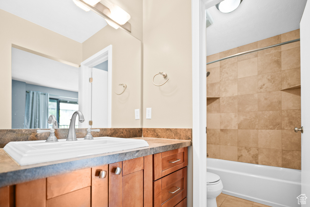 Full bath with vanity,  shower combination, and tile patterned floors