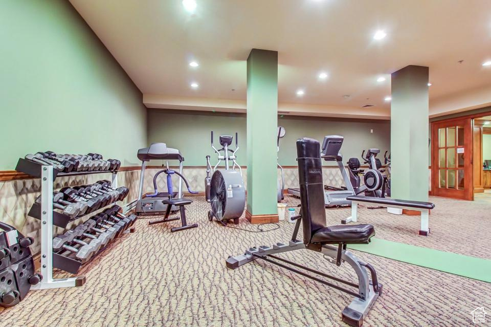 Exercise room with carpet floors and recessed lighting