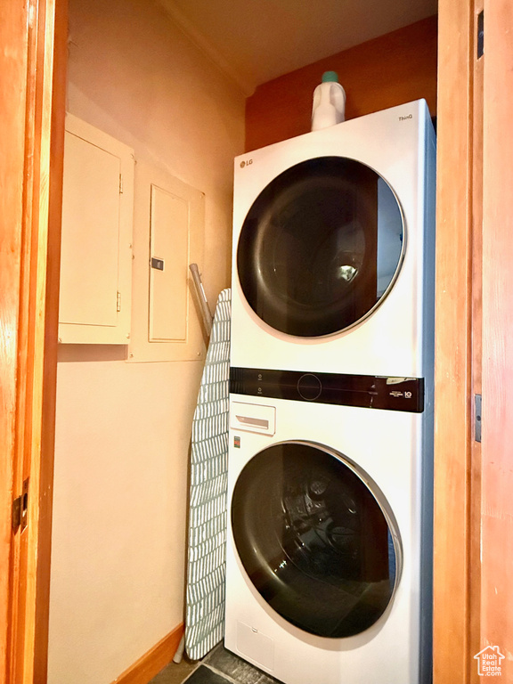 Washroom featuring stacked washer and dryer and electric panel