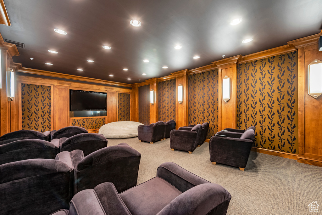 Carpeted home theater room featuring visible vents, ornamental molding, and recessed lighting