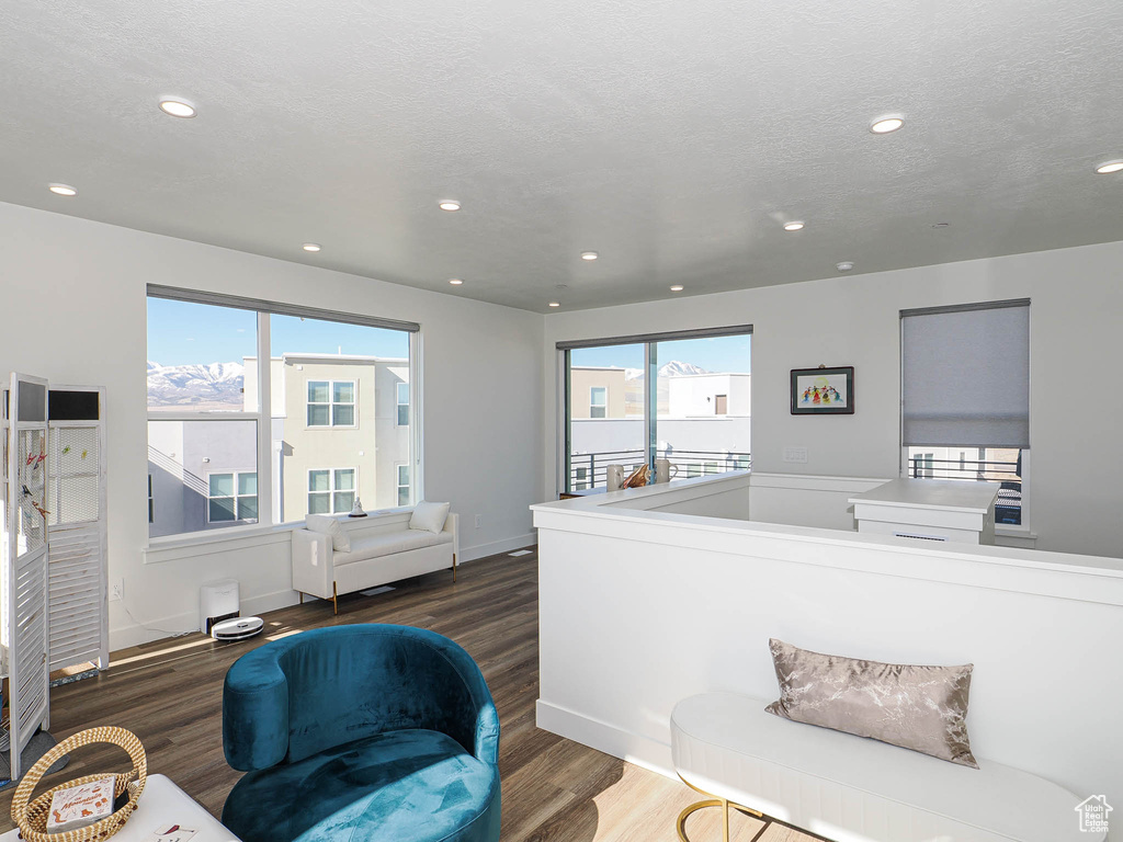 Interior space featuring wood finished floors, recessed lighting, baseboards, and a textured ceiling