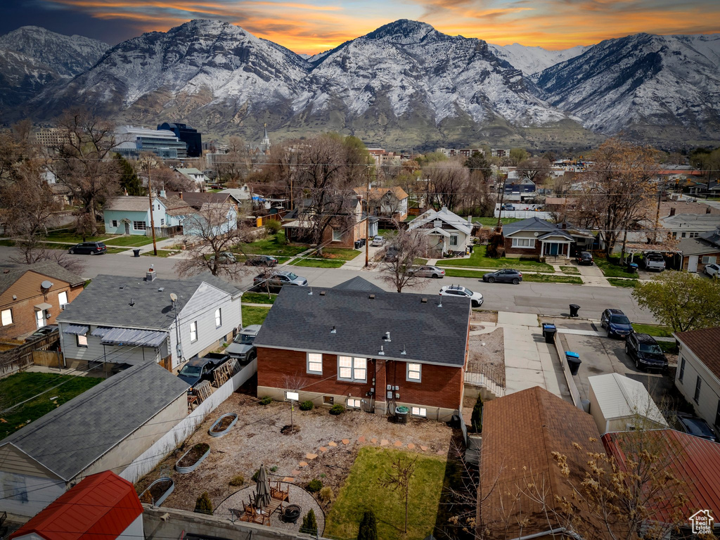 Aerial view at dusk featuring a residential view and a mountain view