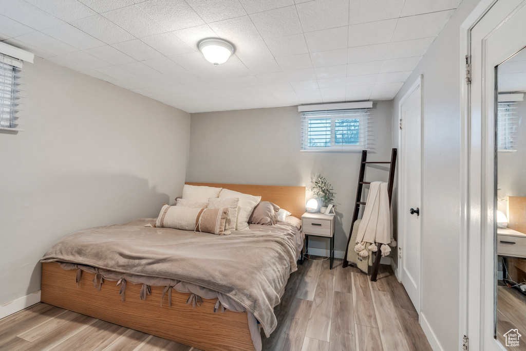Bedroom featuring baseboards and light wood-type flooring