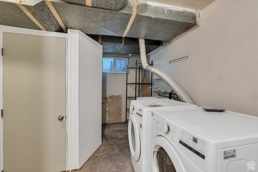 Laundry room featuring washing machine and clothes dryer and laundry area