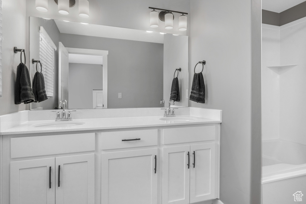 Full bathroom featuring double vanity and a sink