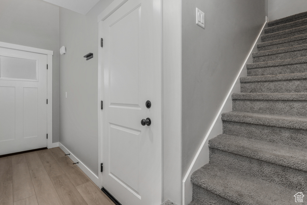 Stairs with baseboards and wood finished floors