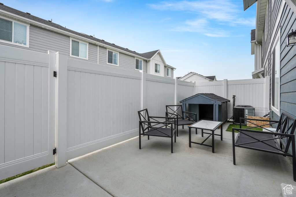 View of patio / terrace with cooling unit and a fenced backyard