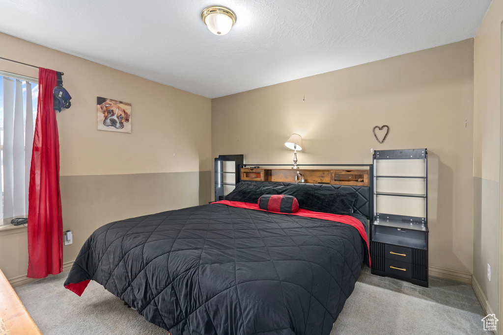 Bedroom featuring baseboards and carpet