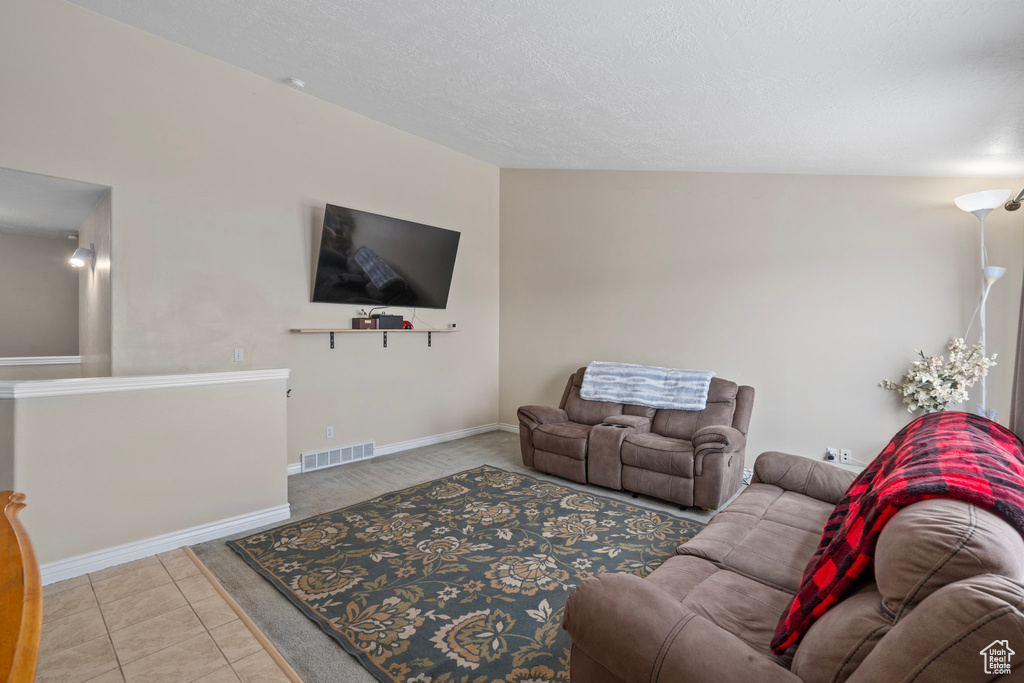 Tiled living area with baseboards and visible vents