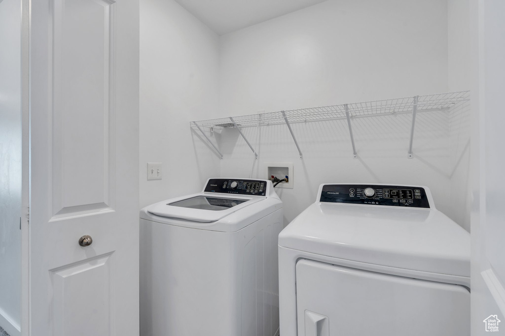 Laundry room featuring laundry area and washer and clothes dryer