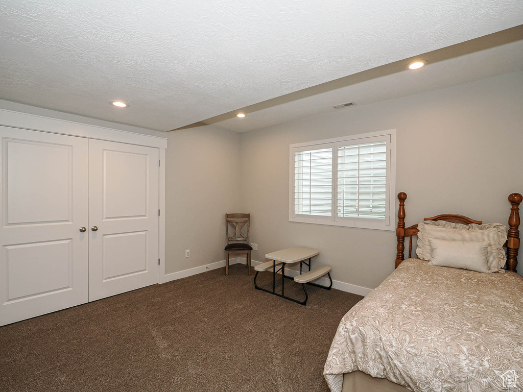 Bedroom featuring baseboards, recessed lighting, carpet, and a textured ceiling