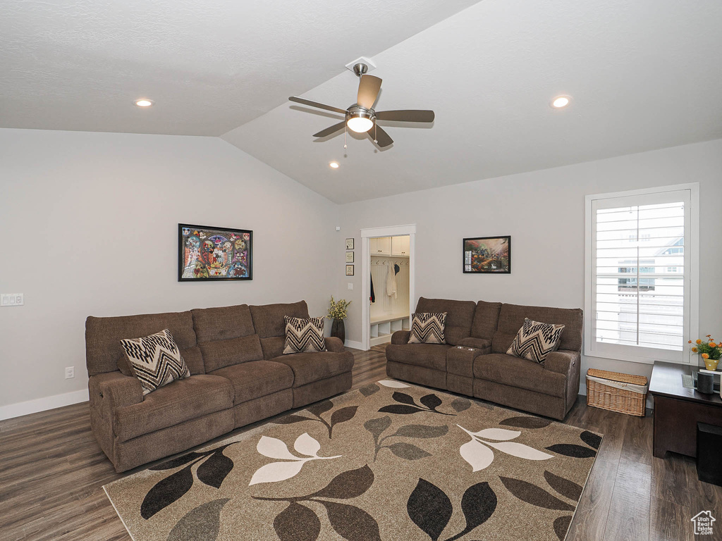 Living area featuring baseboards, ceiling fan, wood finished floors, recessed lighting, and vaulted ceiling
