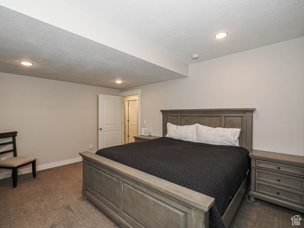 Carpeted bedroom featuring baseboards, recessed lighting, and a textured ceiling