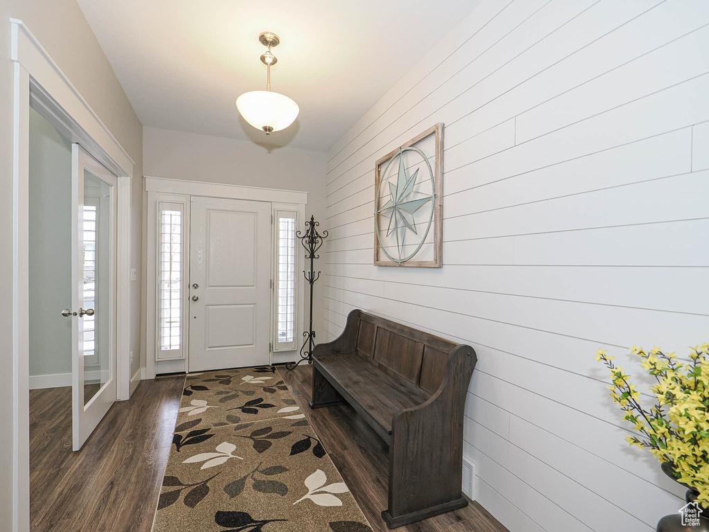 Entrance foyer with dark wood finished floors and baseboards