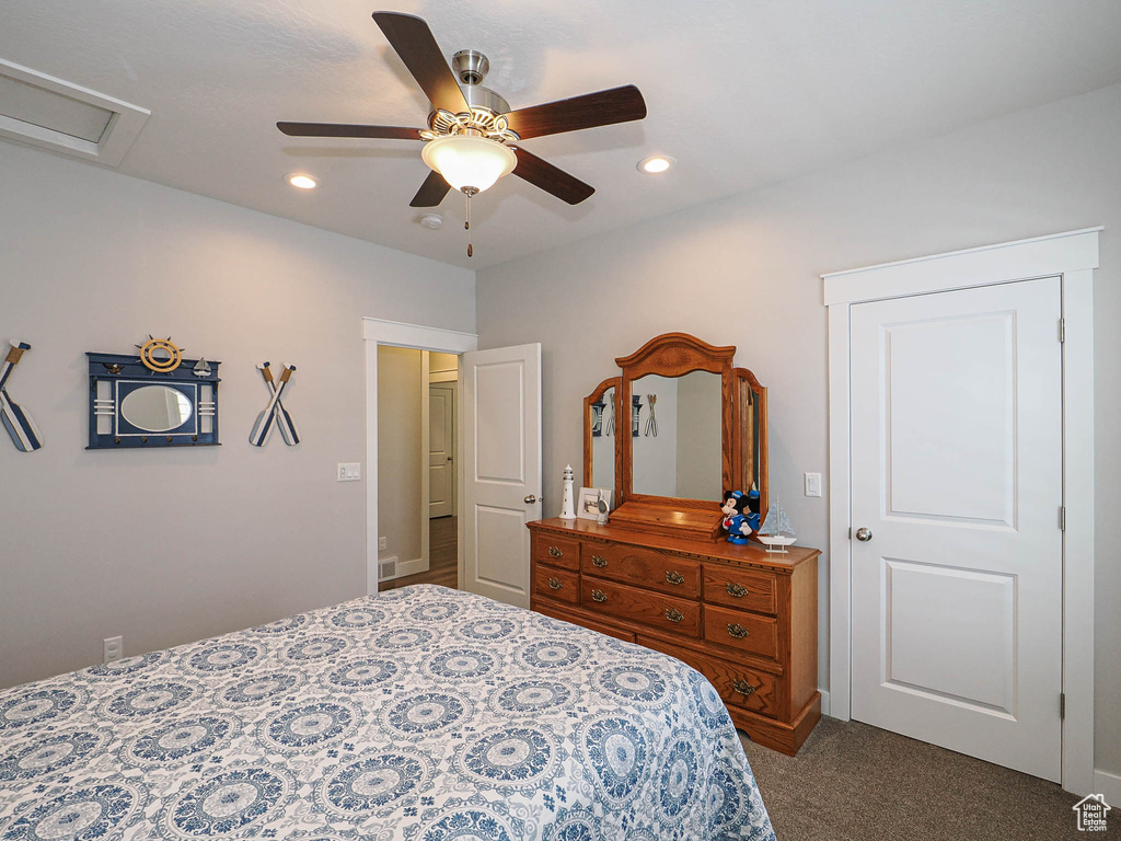 Bedroom with attic access, dark colored carpet, recessed lighting, and a ceiling fan