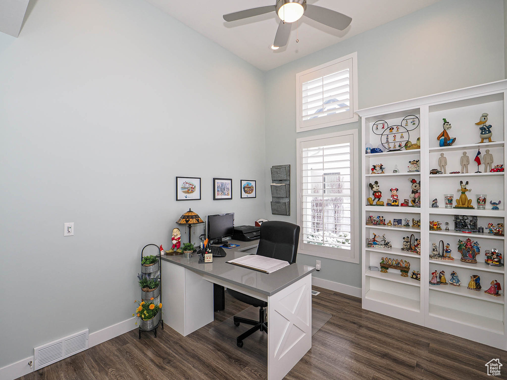 Office space featuring a ceiling fan, dark wood-type flooring, baseboards, and visible vents