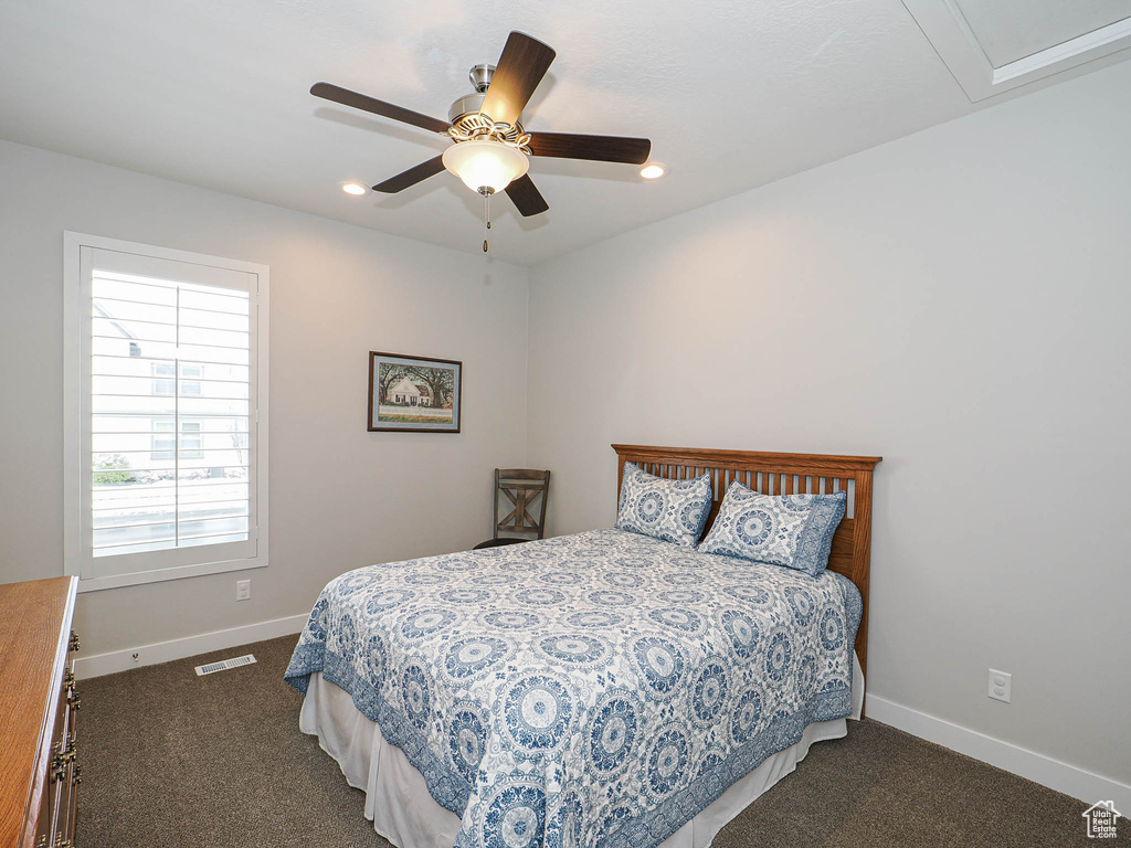 Bedroom with dark carpet, baseboards, visible vents, and recessed lighting