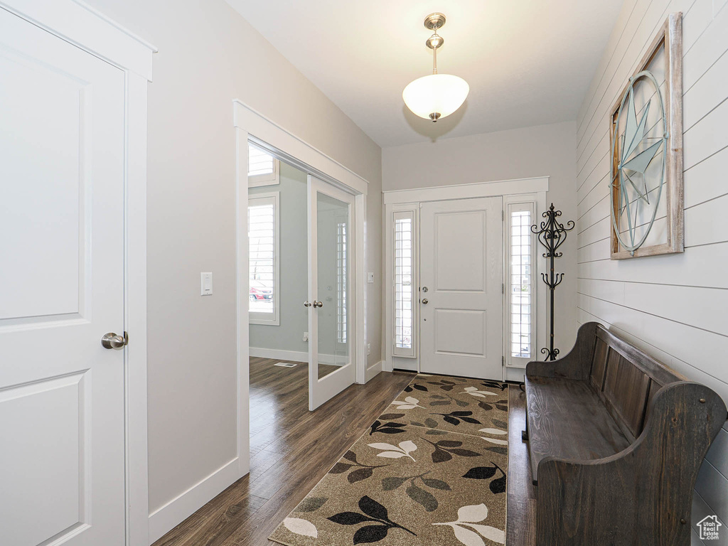 Entrance foyer with baseboards and dark wood finished floors