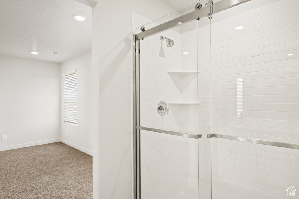 Bathroom with baseboards, a stall shower, and recessed lighting