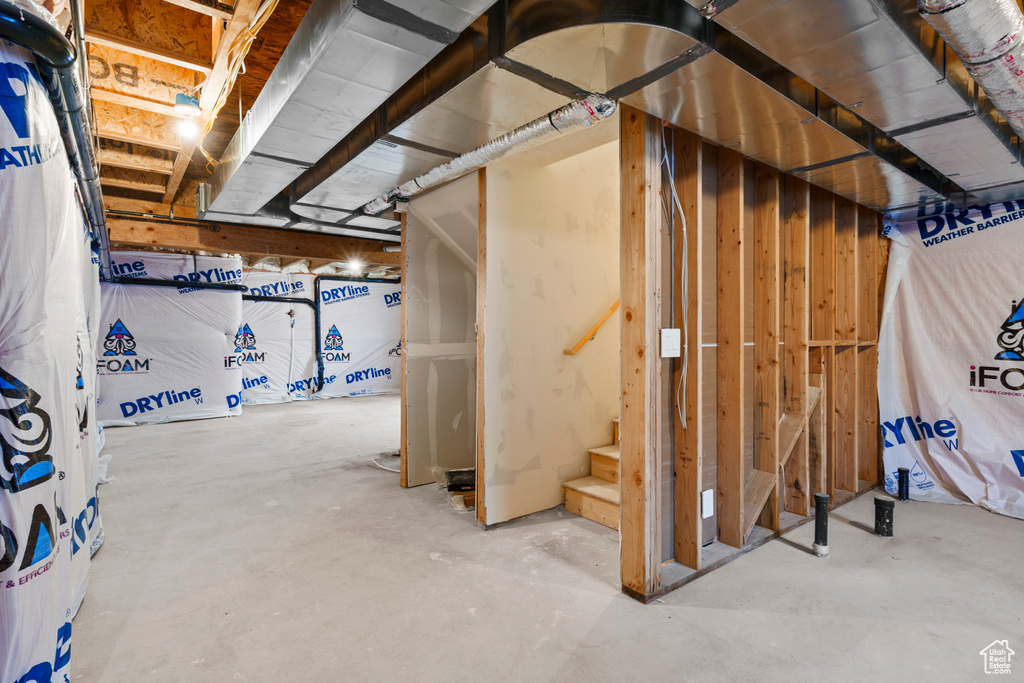 Unfinished below grade area featuring stairway