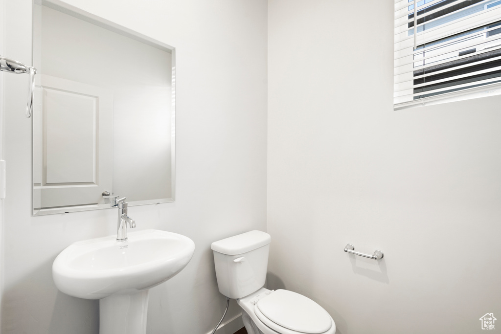 Half bathroom with a sink and toilet