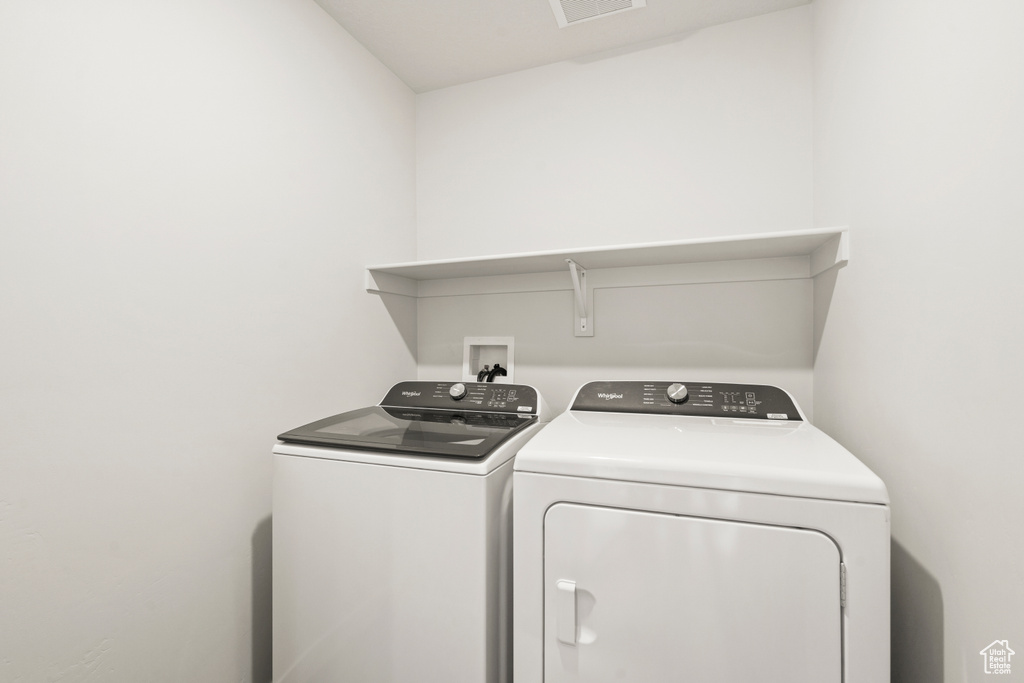 Washroom with laundry area and washing machine and clothes dryer