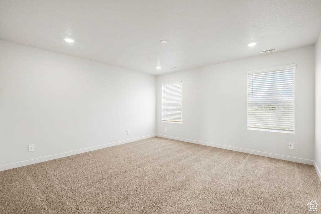 Unfurnished room with recessed lighting, baseboards, visible vents, and light colored carpet