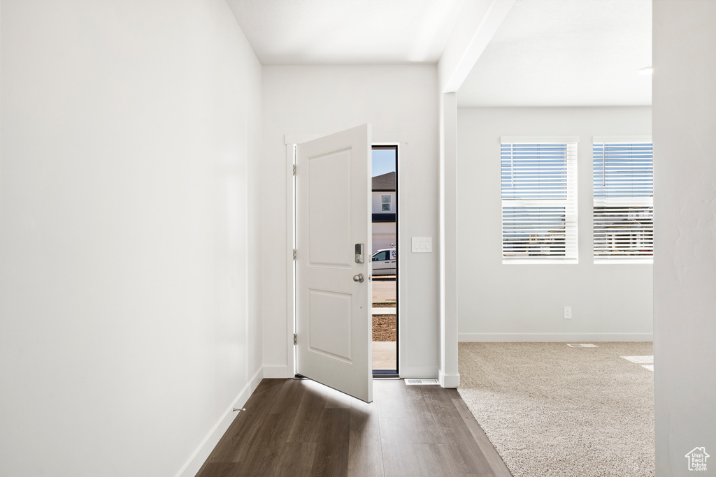 Foyer entrance with baseboards and dark wood finished floors