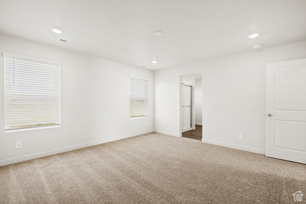 Unfurnished bedroom with baseboards, carpet flooring, recessed lighting, and visible vents