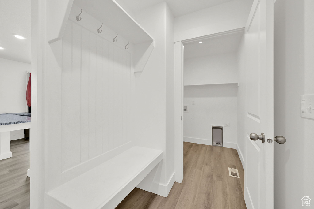Mudroom with wood finished floors and recessed lighting
