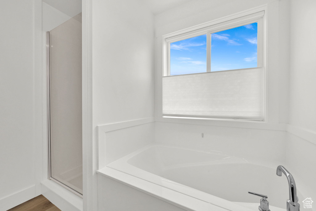 Bathroom with a garden tub and a shower stall