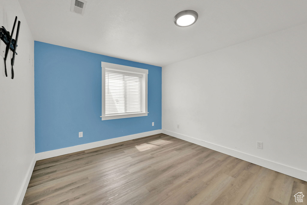 Empty room with wood finished floors and baseboards
