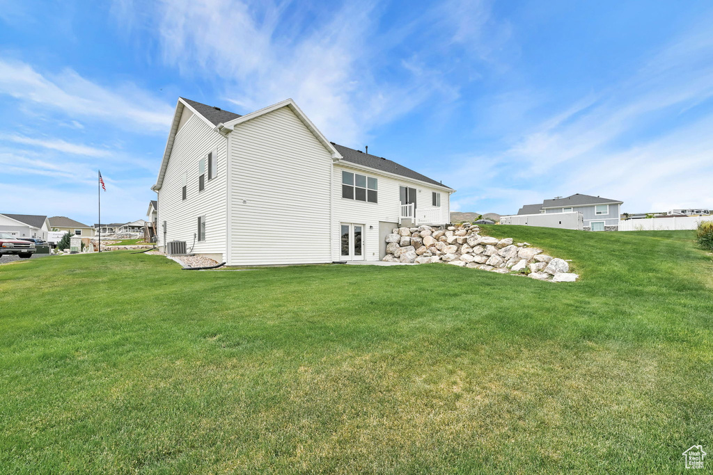 Back of house with a lawn and french doors