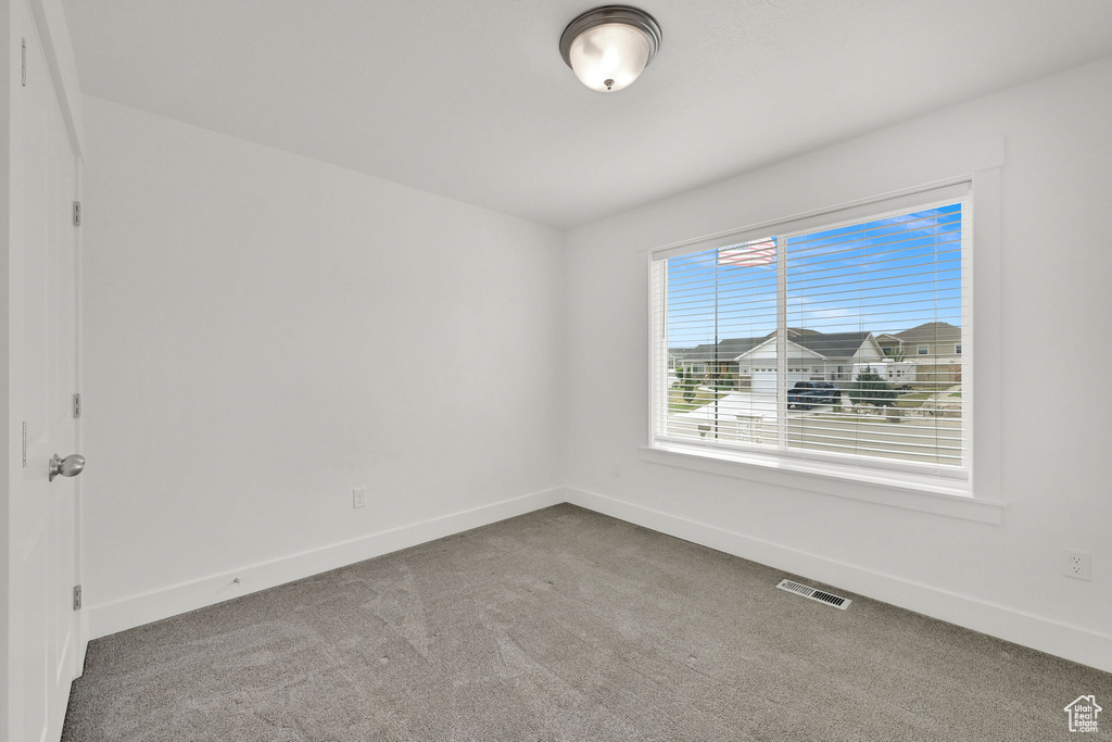 Unfurnished room with baseboards and carpet floors