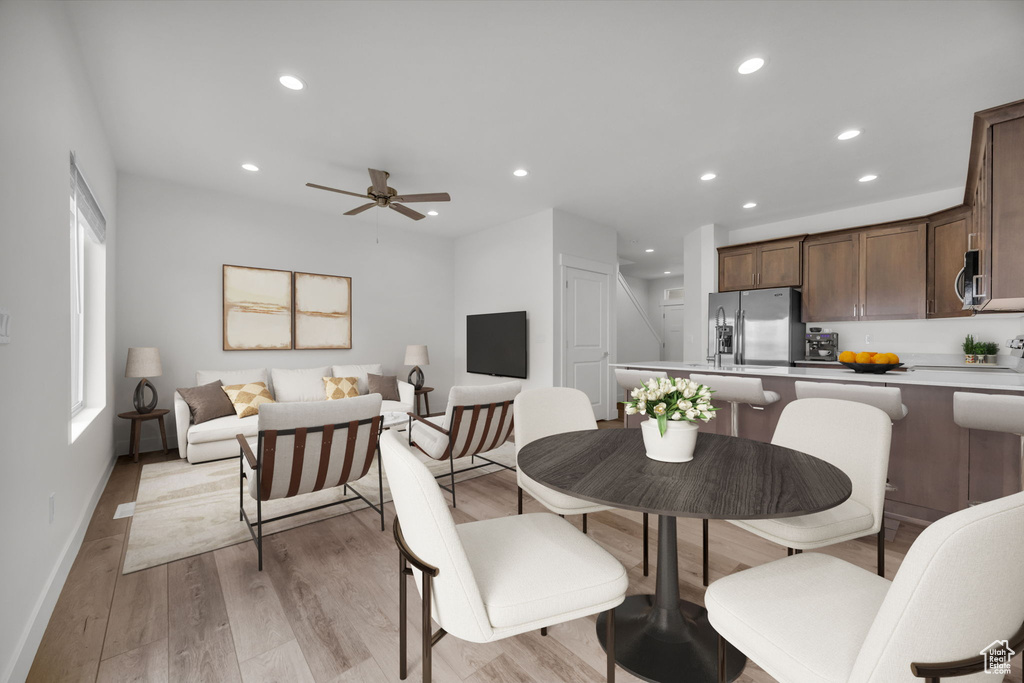 Dining room with light wood finished floors, recessed lighting, and ceiling fan