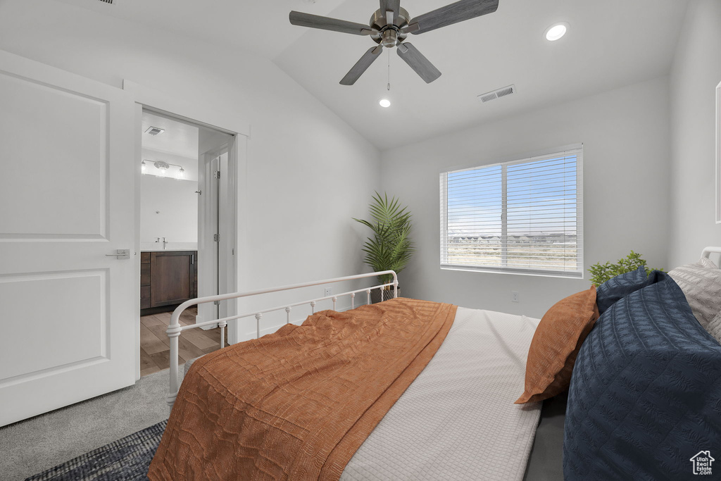 Carpeted bedroom featuring vaulted ceiling, recessed lighting, ceiling fan, and connected bathroom