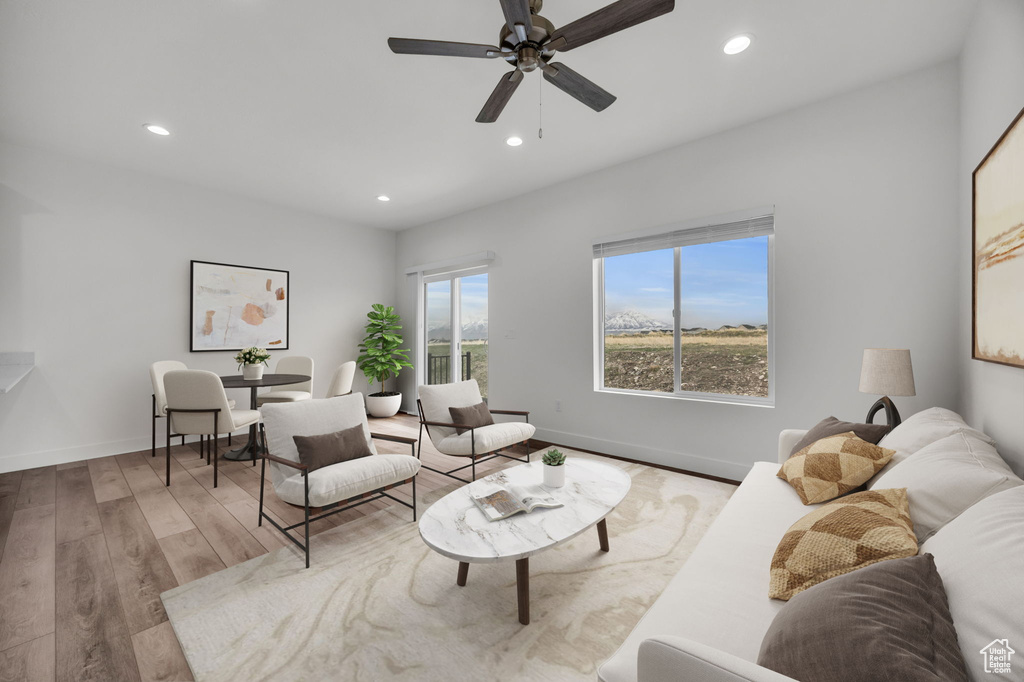 Living area featuring wood finished floors, recessed lighting, and a ceiling fan