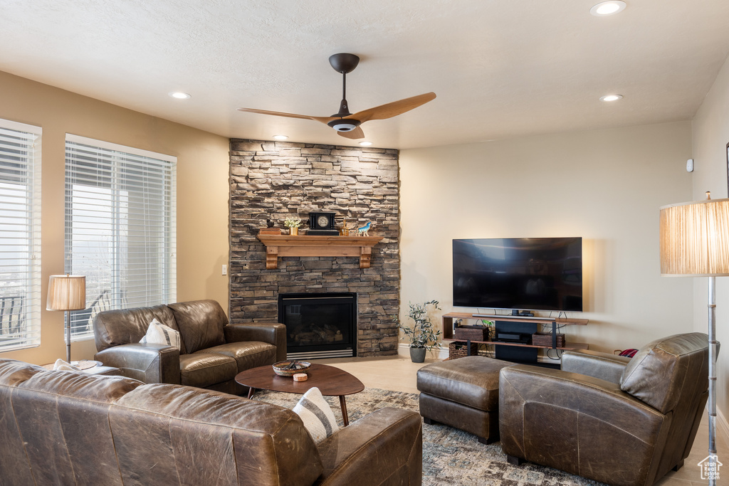 Living area featuring a fireplace, recessed lighting, and a ceiling fan