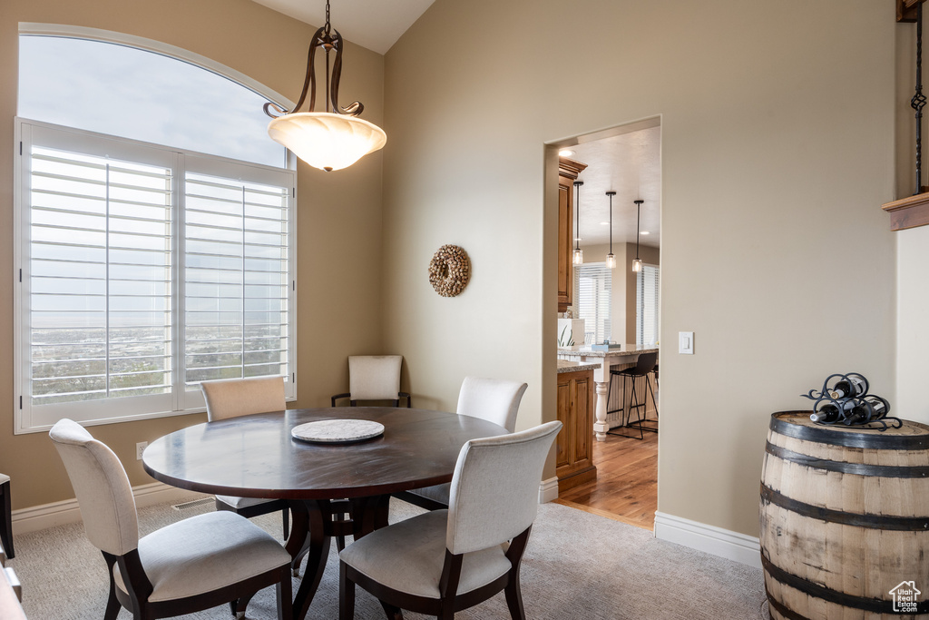 Dining room featuring baseboards and light colored carpet