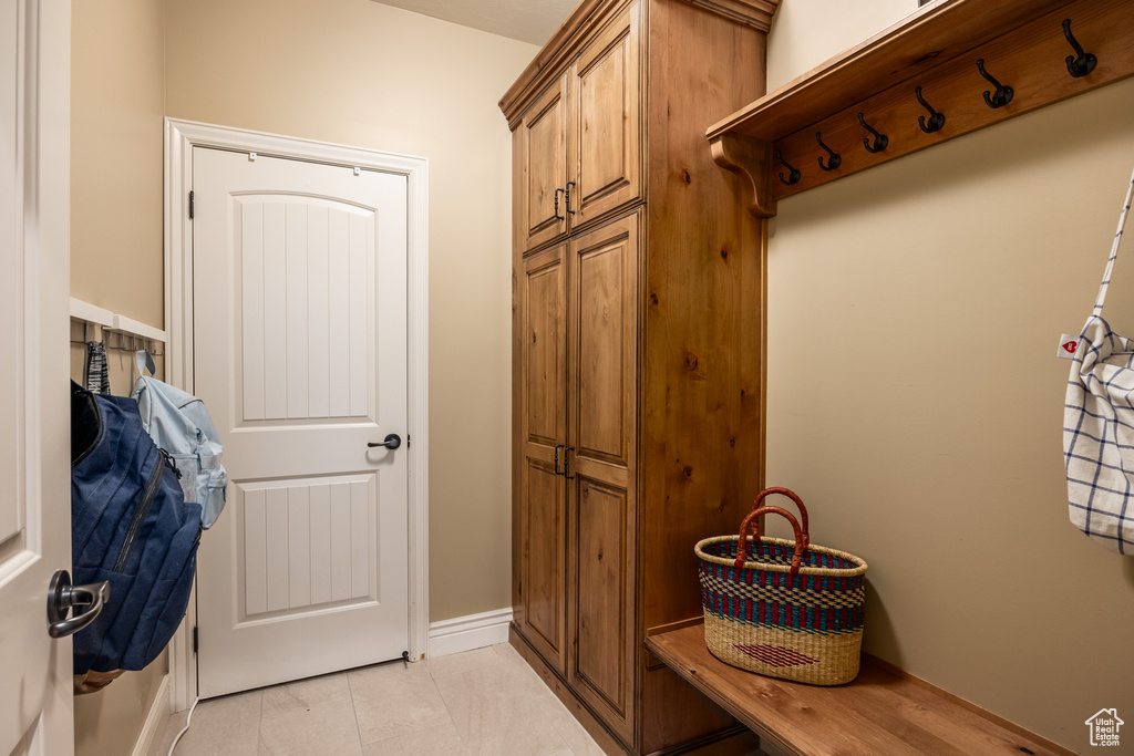 Mudroom with light tile patterned flooring