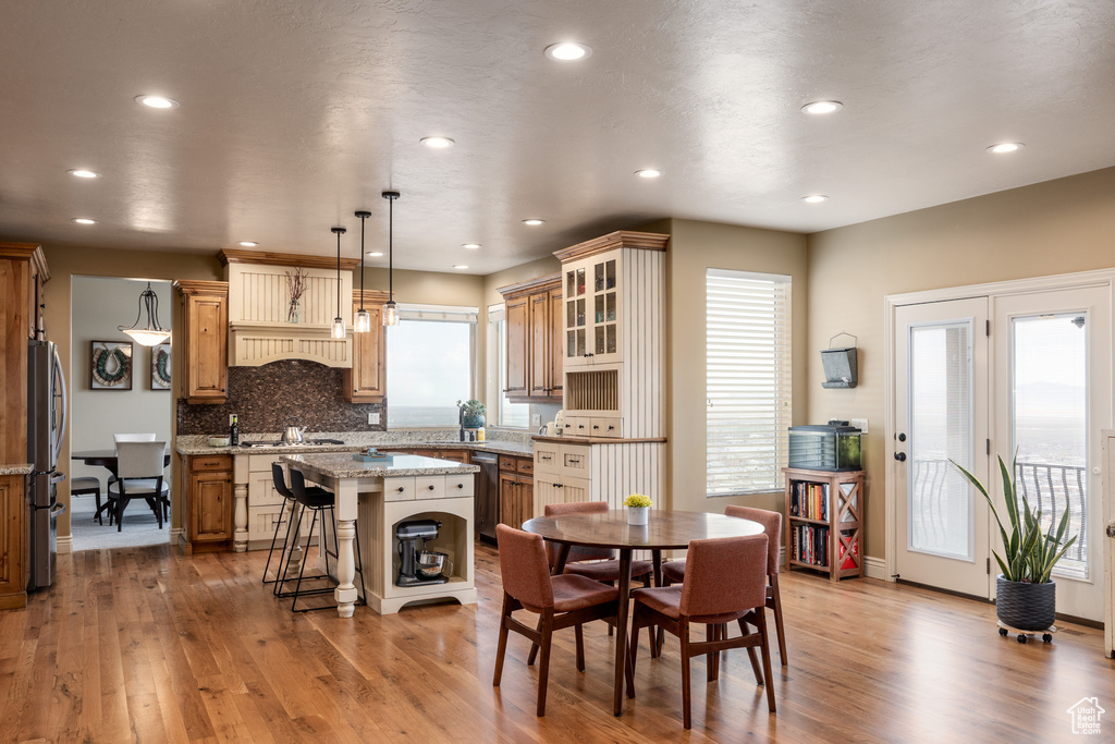Dining area featuring light wood-type flooring and recessed lighting