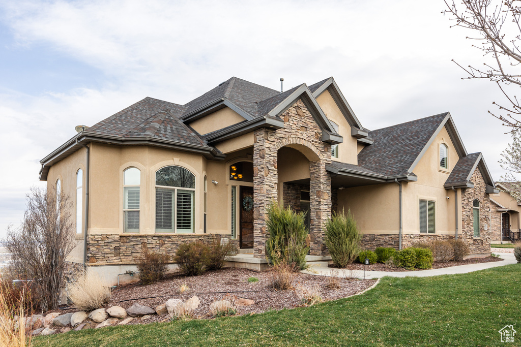 View of front of home with stone siding and stucco siding