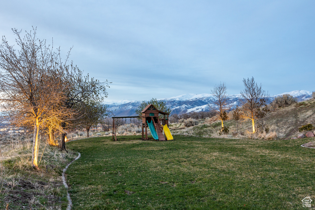 View of yard featuring a mountain view and a playground