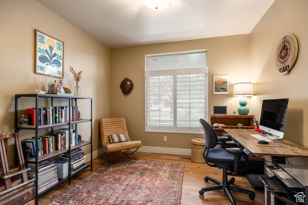 Office area with baseboards and wood finished floors