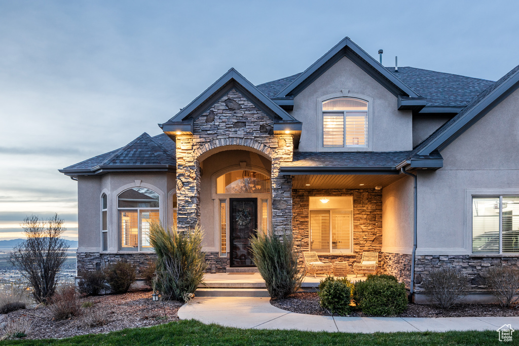 French country style house featuring stone siding and stucco siding